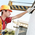 Worker painting commercial exterior wall